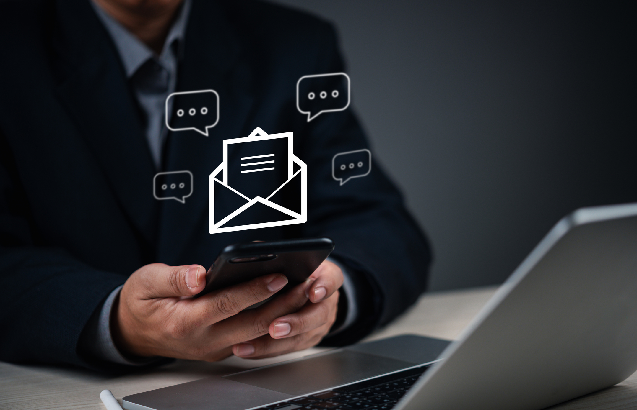 businessman using a smartphone for digital communication, with email and chat icons online messaging. networking modern corporate environment. Ideal email marketing, online messaging, and remote work